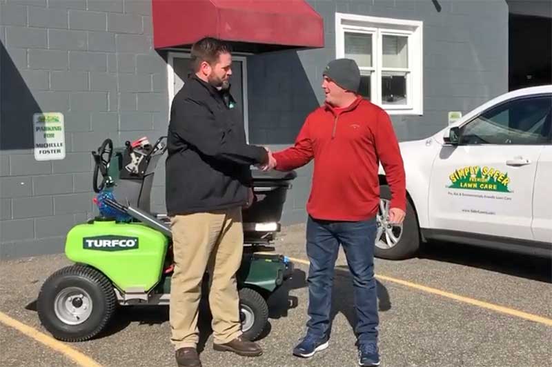 Mitch Foster (right), took delivery in a mid-February of a new Turfco T3100 riding spreader and aerator from Brad Hendrickson, regional sales manager, Turfco Manufacturing. Foster accepted the new machine on behalf of his company, Simply Safer Lawn Care, of Wrentham, Mass. (Photo: Turfco)