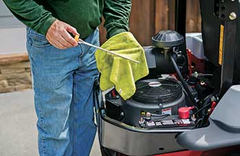 Person performing engine maintenance (Photo: Exmark)