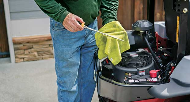 Person performing engine maintenance (Photo: Exmark)