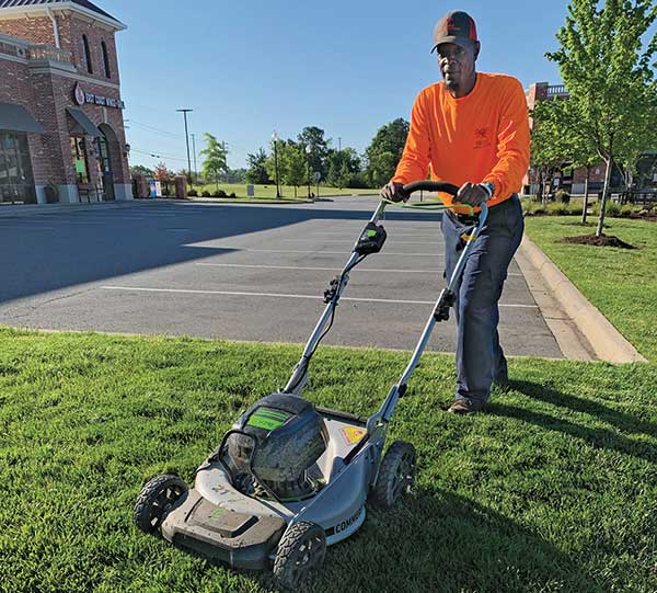 Crew member mowing (Photo: Phoenix Landscape Management)