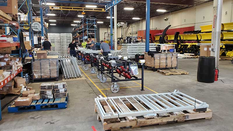 Putting snow plow assembly on hold, SnowPlow's warehouse aisles were converted to storage bays for the large quantity of hospital bed components. (Photo: SnowWolf)