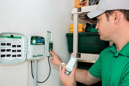 Tech programming a controller (Photo: Rain Bird Corp.)