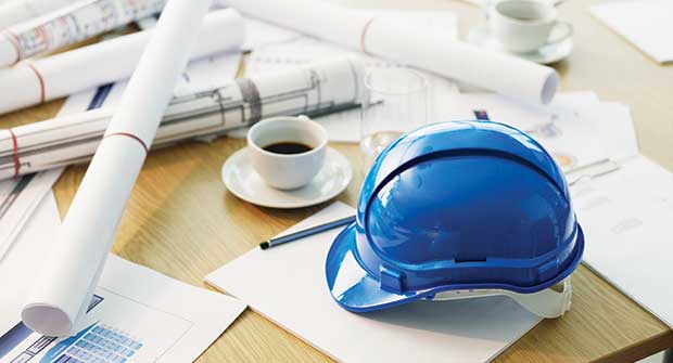 Hardhat and construction plans (Photo: Chris Ryan/OJO Images/Getty Images)