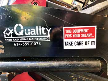 Sign on piece of equipment (Photo: Quality Yard and Home Maintenance)