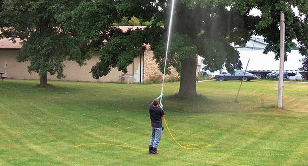 Crew member using weather-based irrigation. (Photo: Pacific Landscape Management)