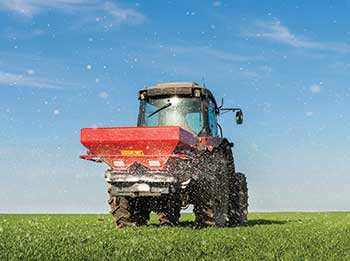 Spreading enhanced-efficiency fertilizers (Photo: fotokostic/iStock / Getty Images Plus/Getty Images)