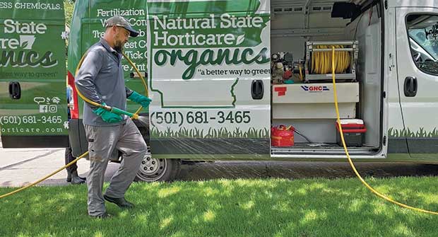 Person spraying lawn (Photo: Natural State Horticare)