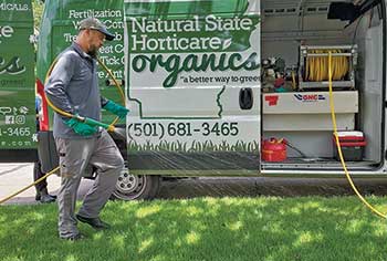 Person spraying lawn (Photo: Natural State Horticare)