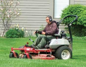Crew member mowing (Photo: Twin Oaks Landscape)