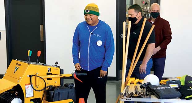 Edgar Contreras (left) is presented with his new equipment by Bear Reynolds of Vermeer and Chris Brouwers with KS Energy. (Photo: Vermeer)