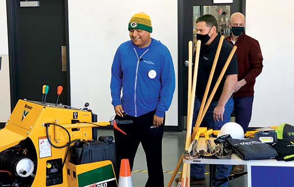 Edgar Contreras (left) is presented with his new equipment by Bear Reynolds of Vermeer and Chris Brouwers with KS Energy. (Photo: Vermeer)