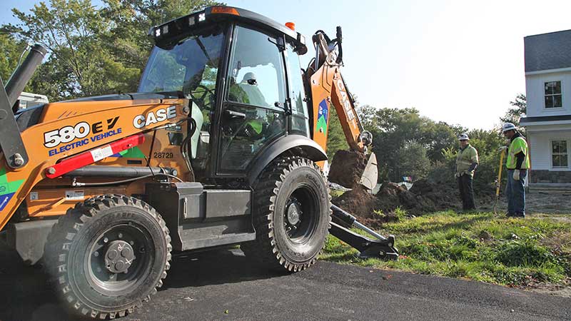 A crew with National Grid uses the Case 580 EV backhoes from Case Construction Equipment. The backhoes require no diesel and produce zero emissions. (Photo: Case Construction Equipment)