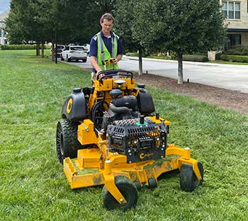 Person setting boundary on robotic mower (Photo: Greenzie)