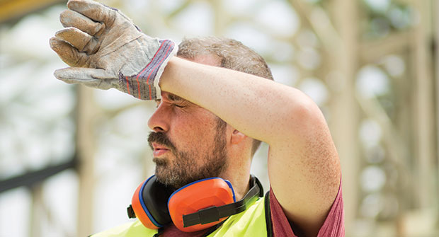 Landscaper shading eyes during hot day (Photo: JulieanneBirch/iStock / Getty Images Plus/Getty Images)