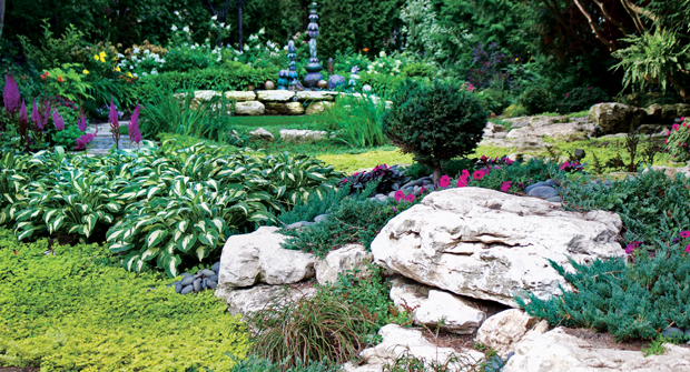 The garden showcases the client’s terra-cotta art. Other features include eroded limestone boulders sourced from a farmer’s fence row and plantings reflective of the Japanese garden influence. (Photo courtesy of Kimber Johnson)