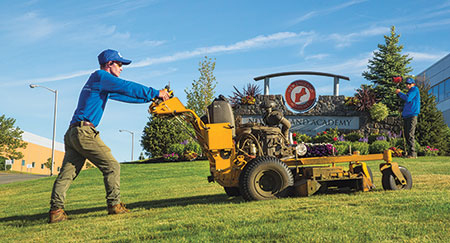 Person mowing property (Photo: ND Landscape Services)