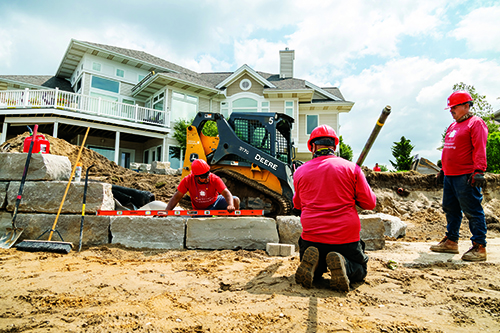 DeHamer Landscaping crews install a retaining wall in near Grand Rapids, Mich., using a Deere compact track loader (Photo: Marvin Shaouni).