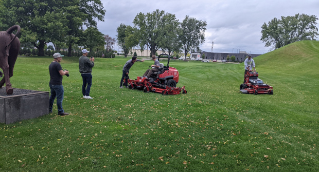 Visitors to Toro's Minneapolis headquarters test the company's 144-inch zero-turn mower (left) and the GrandStand Revolution electric stand-on mower (right) (Photo: LM Staff).