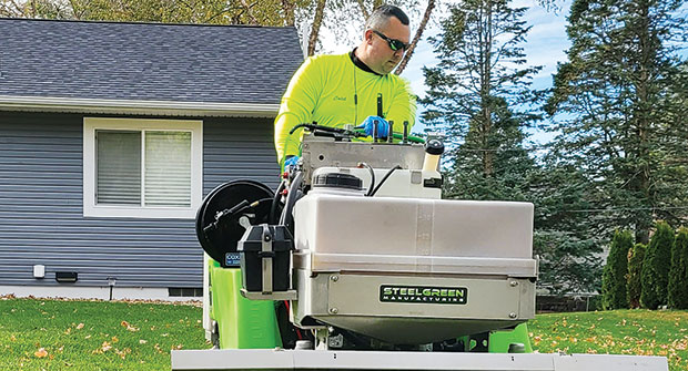Tech operating spreader-sprayer (Photo: Left Side Lawn Care)