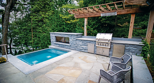 This space was originally set to be a garden, before a mid-project change turned it into this outdoor grill and chill spot. (Photo: Landmark Landscapes)