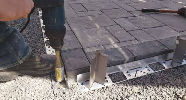 Joshua Jones of Mass Hardscapes says he likes Pave Tool Innovators’ Quick-E-Hybrid Edging for its strength and ease of installation. (Photo: Joshua Jones)