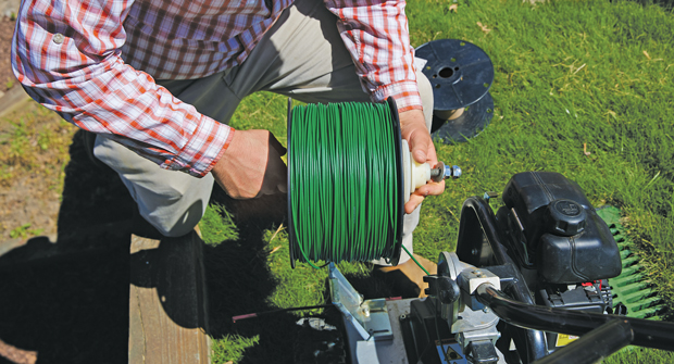 According to Justin Mosley of Plants Creative, wire must be laid a certain distance from obstacles. For instance, boundary wire must be put four inches away from a flat driveway. (Photo: Chris Aluka Berry)