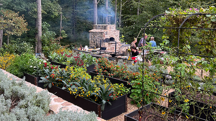A client of John Phillips, president of Gardens For Living in North Carolina grills for members of Jeffrey Scott's High Achievers Peer Group. (Photo: Jeffrey Scott)