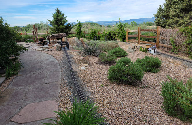 A view of the completed flagstone pathway features both new and old stone. The walkways encircle the home. (Photo: Alpine Gardens)