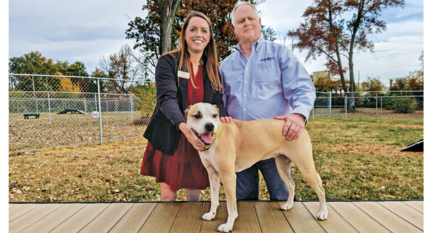 Kris Kiser with Alisa Gray, president and CEO of the Kentucky Humane Society, and Mulligan the TurfMutt at TurfMutt Park, a dog park and exercise facility built by the Foundation for the KHS. (Photo: TurfMutt Foundation)