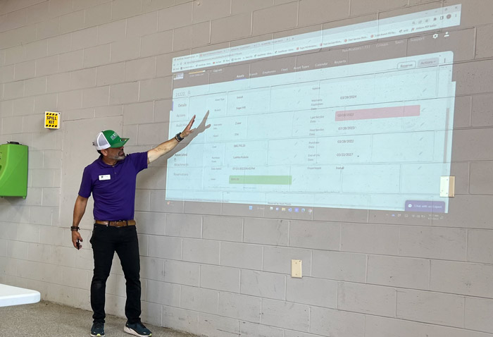 Nelson Alvarado, fleet manager for Russell Landscape, walks NALP Field Trip attendees through the company’s fleet management system. at his company's Sugar Hill, Ga., headquarters. (Photo: LM staff)