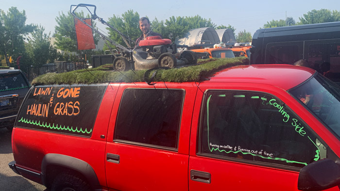 Complete with live sod, a lawn mower and fully functional sprinkler heads (operating in this picture), this suburban served as home base for part of Pacific Landscape Management's “Lawn Gone and Hauling Grass” Hood to Coast relay runners. (Photo: Pacific Landscape Management)