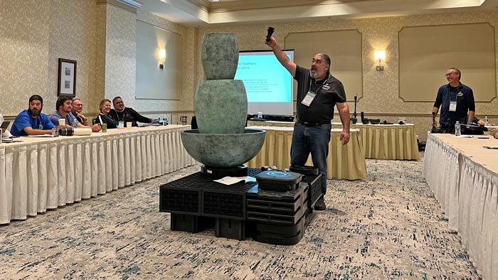 Demi Fortuna, director of product information at Atlantic-Oase, shows attendees some creative and out-of-the-box solutions to common water feature issues. (Photo: LM Staff)