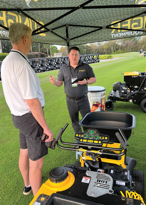 David Cook, CEO of Stinger (right), demonstrates the advanced technology behind one of the many machines he’s invented. (Photo: LM Staff)
