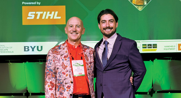 The Grovers take on Provo: Bob Grover (left), president ot Pacific Landscape Management in Hillsboro, Ore., and his son, David, branch manager at Pacific Landscape Management and NCLC chairperson, pose for a picture on the main stage after the NCLC opening ceremony. (Photo: LM Staff)