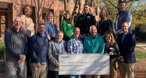 Nufarm’s Blaine Pinkerton (front row, third from right) presents Nufarm’s the check for its sponsorship of the GreenCare for Troops program to the Project EverGreen Board of Directors at the non-profit’s recent board meeting in Raleigh. (Photo: Project EverGreen)