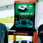 Get to know these guys! Justin Novosel, executive vice president and general manager of North American operations, (left) and Matt Moore, director of robotics sales, for Sunseeker share the frame with the company’s new Orion X7 robotic mower. (Photo: LM Staff)