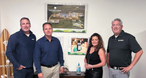 Sipcam Agro is growing: Sipcam Agro CEO and COO Brent Marek and Elizabeth Taras, communications specialist, show the guys a photo of the new production plant in Mississippi the company recently purchased. (Photo: LM Staff)