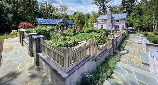 A view of the garden during the first year of growing. The combination of natural stone columns with parged concrete walls is tied together with 2-inch gauged flagstone caps. (Photo: McHale Landscape Design)