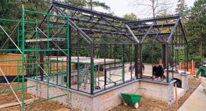 An in-progress shot shows McHale crews constructing the greenhouse on-site. (Photo: McHale Landscape Design)