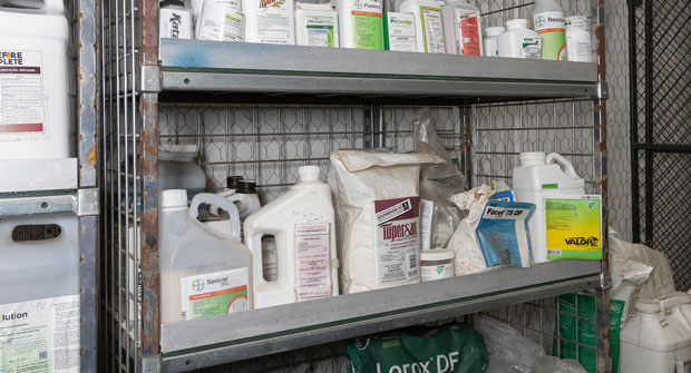 Assorted pesticides are shown safely stored on a shelf. (Photo by Tyler Jones, UF/IFAS)