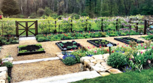 Espalier pear trees surround garden beds with a spring bulb display. (Photo: A Blade of Grass and Michael J. Lee)