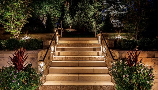 Hidden in Plain Sight One popular technique is to install sconces that shine on pathways while not making the light source too obvious. (Photo: Tom Kessler Photography, courtesy of McKay Landscape Lighting)