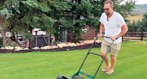 Firm and fast: John Perry, Greene County Fertilizer Co., speeds up the putting green in his backyard with his Hudson Star mower. (Photo: LM Staff)