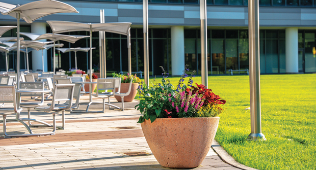 Irrigated planters are changed out with annual and perennial plantings each season to make outdoor dining and break areas pop. (Photo: Yellowstone Landscape)