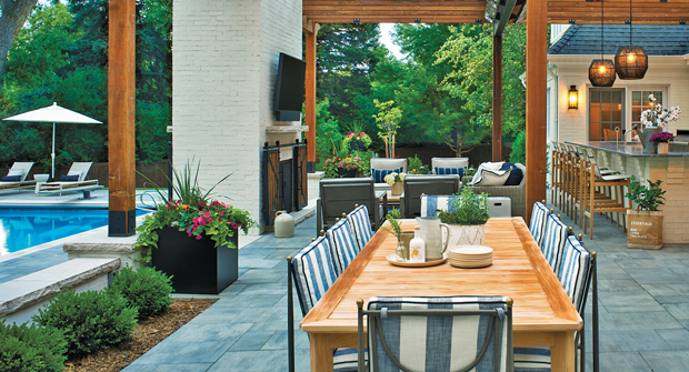 To create the illusion of separate rooms, the designer installed a fireplace, which also serves as a backdrop for the family’s outdoor living area. (Photos: Designs by Sundown)