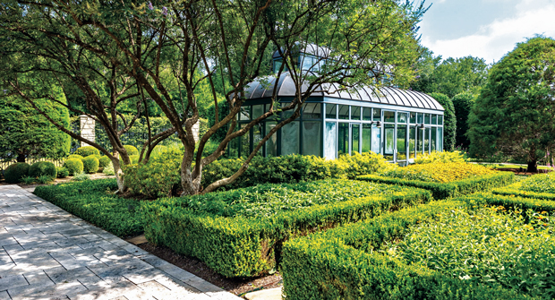 The greenhouse is important for the landscape as an interior fountain controls humidity levels and freeze-sensitive plants like sago palms are moved inside during the winter months. (Photo: Southern Botanical)