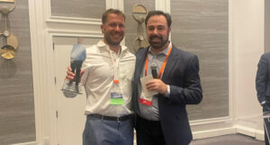 Mat Davis (left), owner, College Fund Landscaping, Plano, Texas, was honored with the ACE Community Impact Award, presented by Michael Bosco. (Photo: McFarlin Stanford)