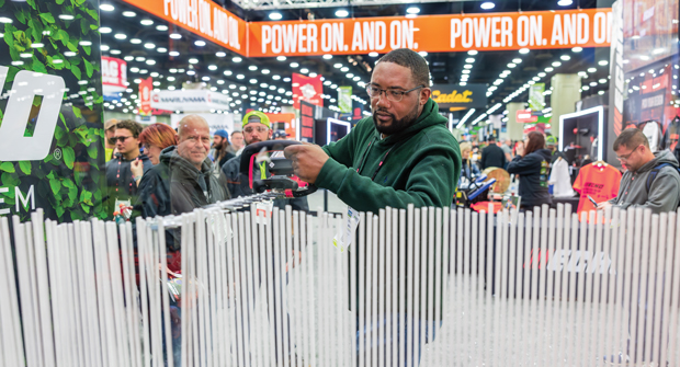 An attendee puts a battery-powered hedge trimmer through its paces at the Echo booth. (Photo: courtesy of OPEI)