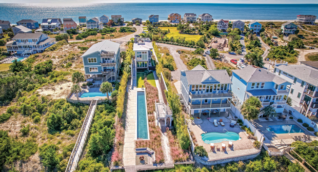 Walton says the long, thin layout of the property made moving machinery and tools difficult, essentially forcing them to build from the back. The dunes can be seen as the lush green patch across the street. (Photo: Courtesy of Element Outdoor Living)