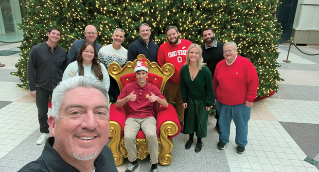 Happy holidays!: Most of the Landscape Management team got together in front of a giant Christmas tree for our holiday card. Seth is in front, with (left to right) Jake Goodman, Sydney Fischer, Scott Hollister, Bill Roddy, Craig MacGregor, Nathan Mader (seated), Rob DiFranco, Payton Szymczak, Nader Hassen and Pete Seltzer. (Photo: LM staff)